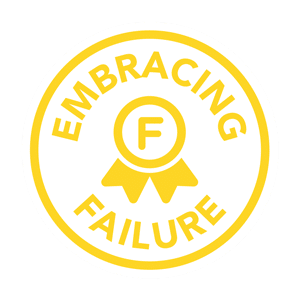 Circular badge logo with the text "Entrepreneurial ESTEAM Education" enclosing the letter "f" in the center, adorned with a ribbon at the bottom, set against a green background.
